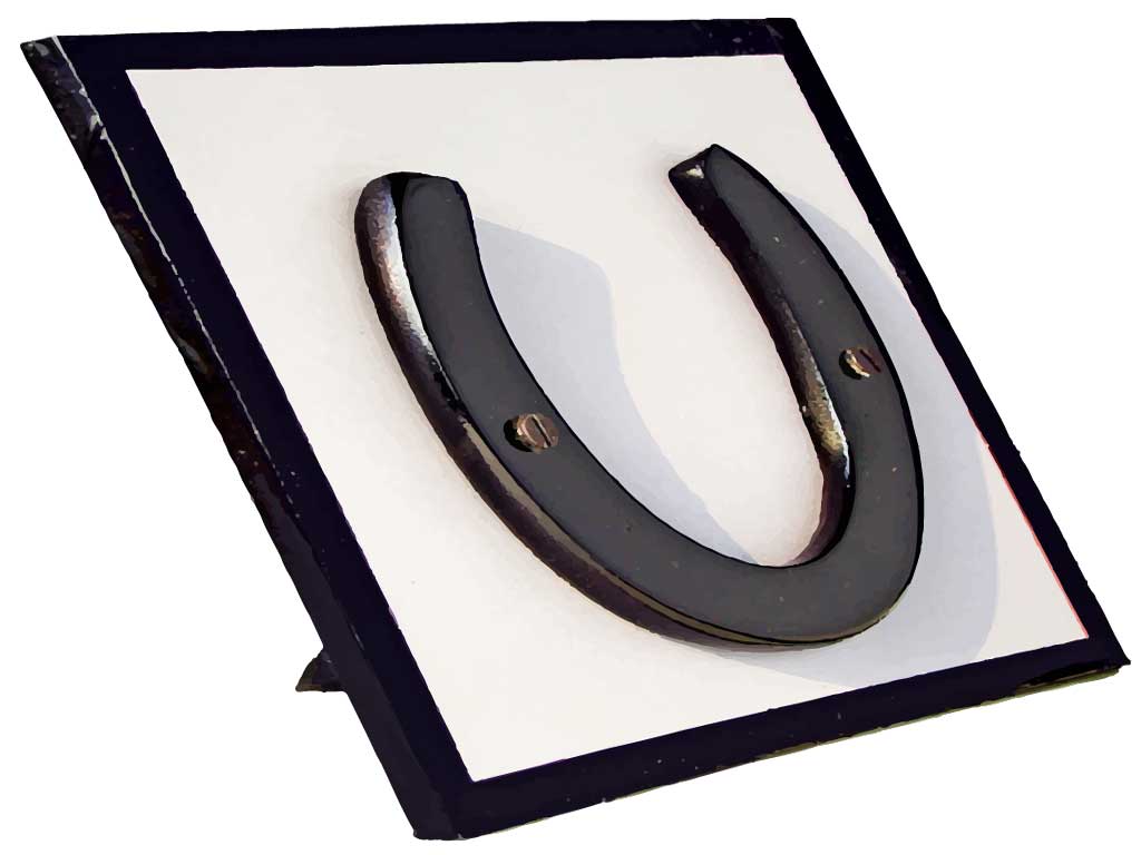 A horseshoe mounted on a wooden frame.