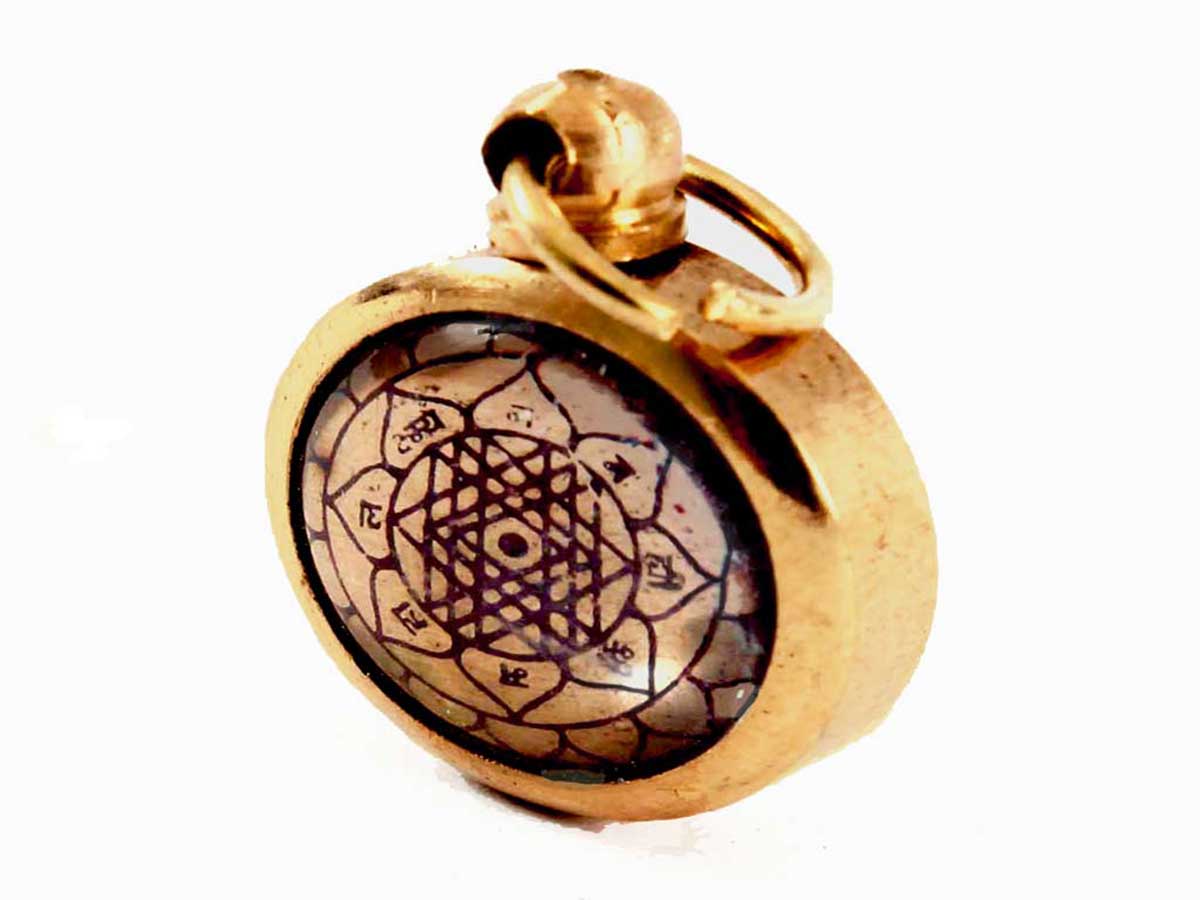 The Shri Yantra talisman in the form of a locket on a white background