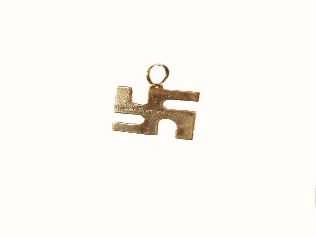 A Swastik locket made in brass on a white background