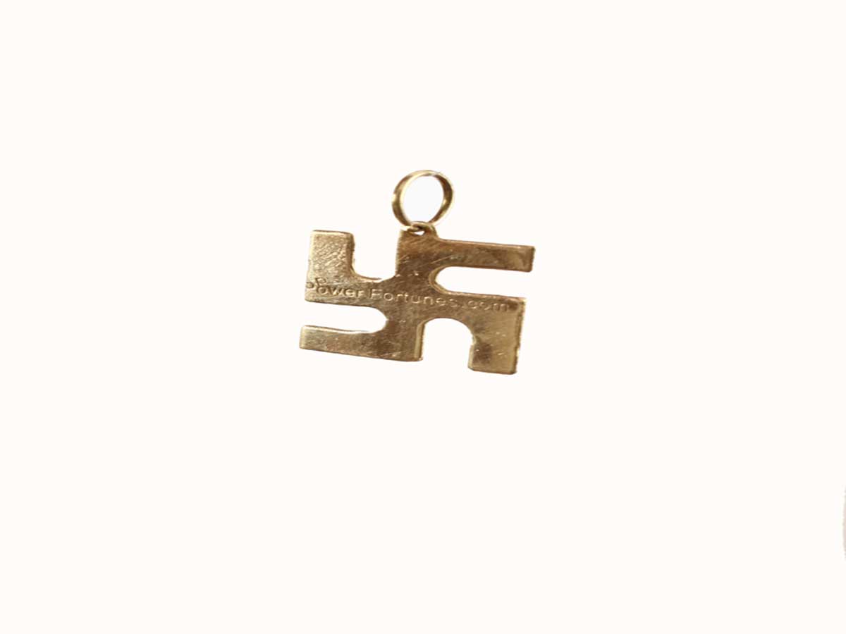 A Swastik locket made in brass on a white background