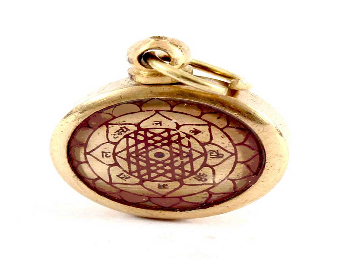 The Shri Yantra talisman in the form of a locket on a white background